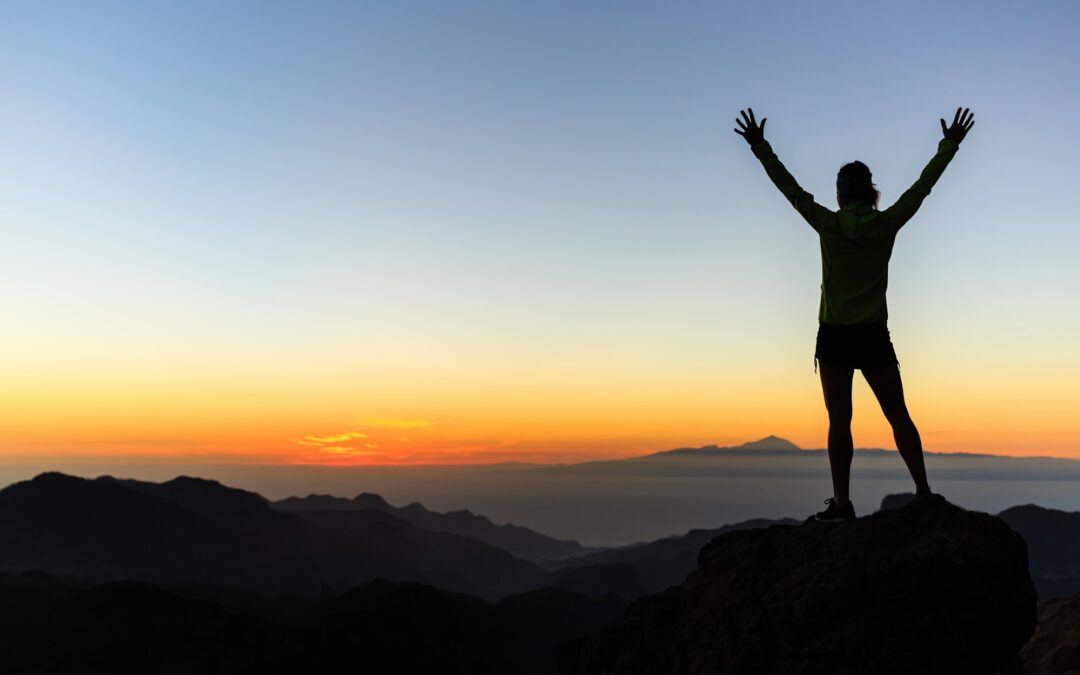 woman climber success silhouette in mountains achievement inspi